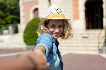 blonde woman holding the hands of his boyfriend