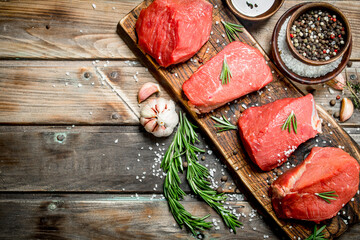 Raw meat. Pieces of fresh beef with spices and herbs .