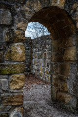 Big walls of an old castle ruin with entrance inside