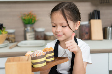Portrait of a little girl in the kitchen of a house having fun playing baking bread