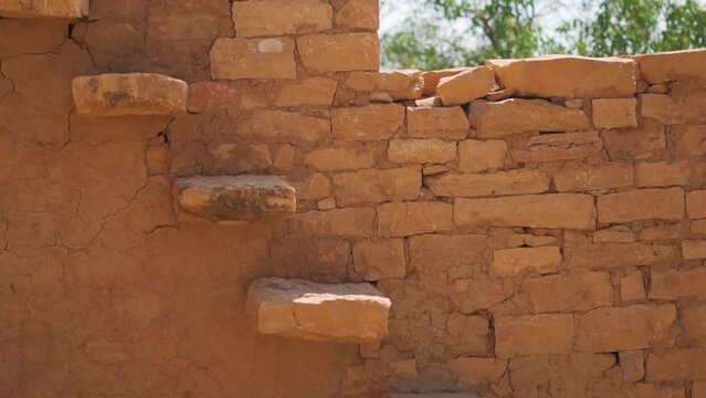 Closeup shot of old stairs of the abandoned house of the Haunted Kuldhara village near Jaisalmer in Rajasthan, India. Old stair in houses made of yellow sand stone at Jaisalmer in Rajasthan. 