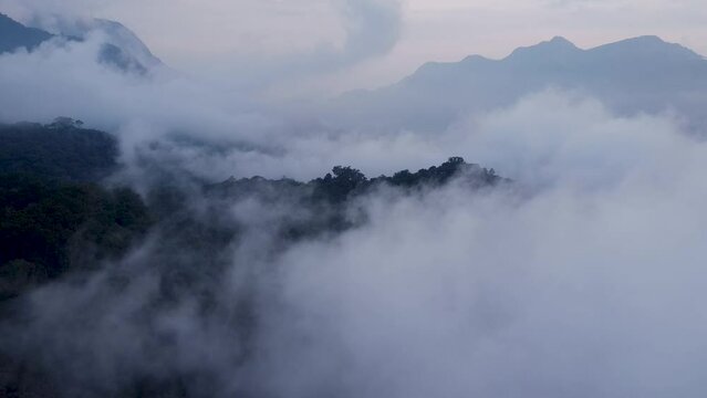 drone video footage showing fog over the mountains in the late afternoon