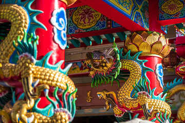 Beautiful Elegant double golden dragon statue decorate the pillars of on a temple for Chinese New Year Festival at Chinese shrine.
