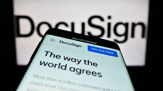 Stuttgart, Germany - 01-13-2023: Mobile phone with website of US electronic signature company DocuSign Inc. on screen in front of logo. Focus on top-left of phone display.