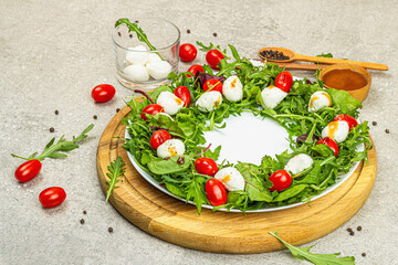 Charcuterie wreath made with mozzarella, cherry tomato, arugula. Fashionable snack, vegetarian food