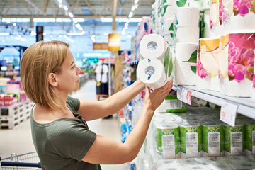 Woman buying toilet paper in store