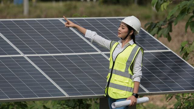 person holding panel. panel installation. Asia woman engineer  on Solar panel clean energy. woman engineer checking solar cell  with solar panel.
