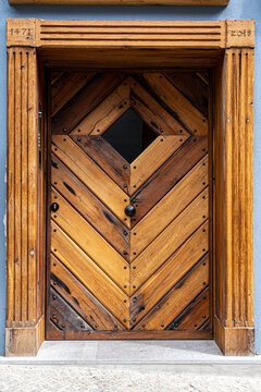 Old door of a historical building with steel door fittings
