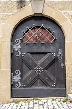 Old door of a historical building with steel door fittings