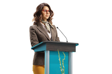 Young woman speaker on a pedestal giving a speech