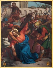 Tuinposter LUZERN, SWITZERLAND - JUNY 24, 2022: The painting Simon of Cyrene helps Jesus carry the cross as part of Cross way stations in the church Franziskanerkirche from 19. cent. © Renáta Sedmáková