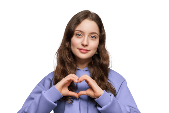 Young woman in a hoodie shows a heart with her hands. Long hair and blue eyes.