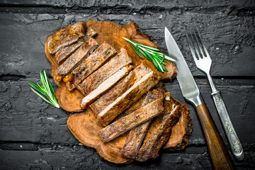 Grilled sliced beef steak with rosemary.