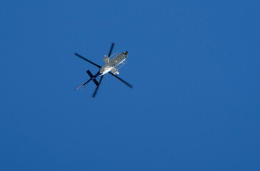 Helicopter against the blue sky on a sunny day