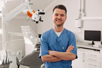 Naklejka na ściany i meble healthcare, profession, stomatology and medicine concept - smiling male middle aged dentist over medical office background