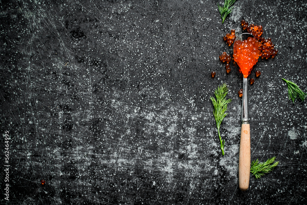 Poster Red caviar in a spoon with dill.