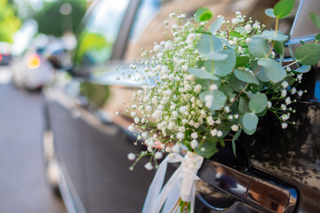 Close up of luxury wedding car flowers decoration.