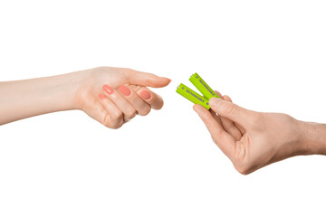 Rechargeable battery offer from a female hand to a male, isolate on a white background.