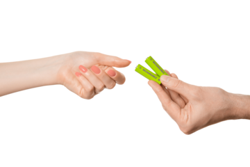 Rechargeable battery offer from a female hand to a male, isolate on a white background.