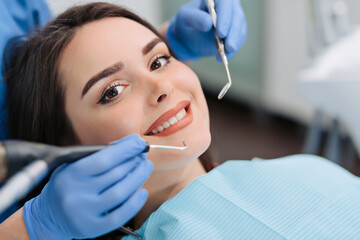 Woman having teeth examined at dentists