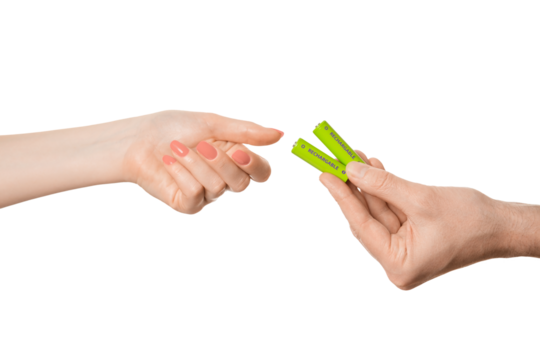 Rechargeable battery offer from a female hand to a male, isolate on a white background.