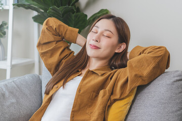 Young woman enjoying mind free moment relax and calm on the sofa at home.