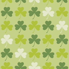 Fototapeta premium Saint Patrick's Day greetings with tree leaf clovers on green background.