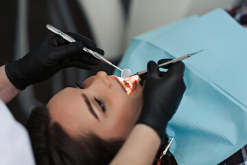 Dentist treats teeth of patient