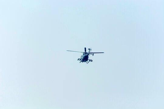Helicopters are flying in isolated blue sky.