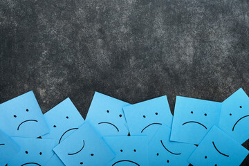 Blue sticky notes blank with drawing sad face on black background with copy space ready for your...