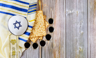 Matzah Pesah Jewish holiday celebration with kiddush six cups of kosher red wine marked as Kiddush for Passover