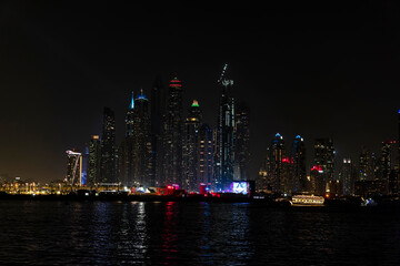 City at night, panoramic scene of downtown reflected Dubai