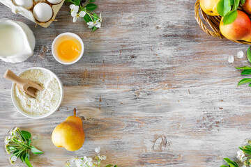 Ingredients for making buns or pies with jam and fresh pears on a wooden background. Top view. Copy Space
