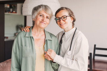 Female nurse doctor caretaker assisting happy senior grandma healthcare homecare concept
