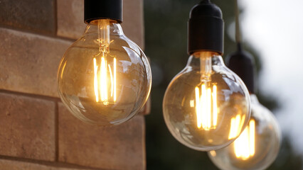 Old vintage light bulbs hanged outdoor.