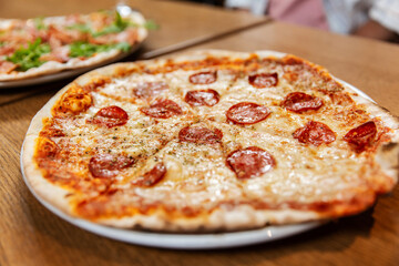 fast food, italian kitchen and eating concept - close up of pizza margherita on wooden table