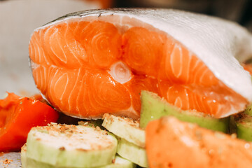 Red fish trout salmon ready for baking with vegetables.