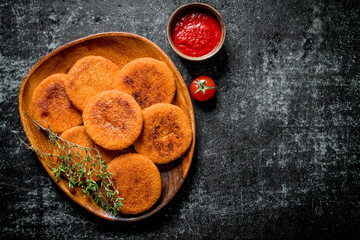 Fish cutlets with thyme and tomato sauce.