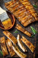Sliced grilled ribs with sauce.