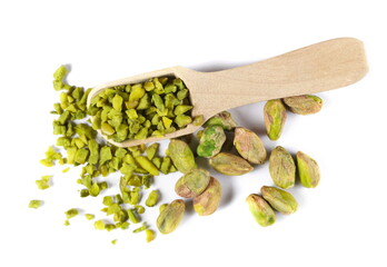 Pistachios chopped and whole peeled pile in wooden spoon isolated on white, top view