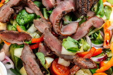 food, cooking and eating concept - close up of duck meat with vegetable salad