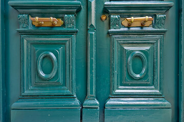 A vintage houses handcrafted green door detail. Beautiful everyday life art objects.