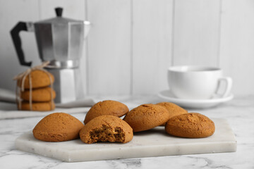 Tasty oatmeal cookies on white marble table