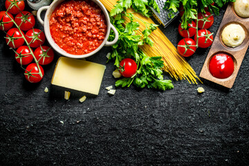 Pasta background. Dry spaghetti with Bolognese sauce,herbs, tomatoes and cheese.