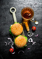 Burgers with beer and onion slices.