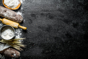 Fragrant rye bread with flour, rolling pin and spikelets.