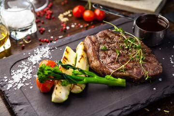 Black Angus New York steak. Marbled beef sirloin from Uruguay. Delicious healthy traditional food closeup served for lunch in modern gourmet cuisine restaurant