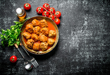 Meat balls with herbs and tomatoes.