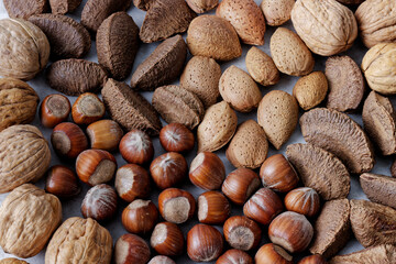 Nuts assortment background. Various nuts with nutshells.
