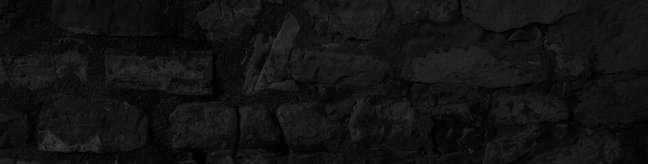 Dark stone texture. Wide panoramic black background with space for design. Web banner, website header